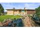 Charming brick ranch-style home with a well-manicured front yard and mature landscaping at 5703 Field St, Arvada, CO 80002