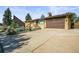 Charming brick home featuring a well-kept lawn and two-car garage at 5703 Field St, Arvada, CO 80002