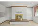 Cozy living room with a painted brick fireplace and hearth, perfect for creating a warm and inviting atmosphere at 5703 Field St, Arvada, CO 80002