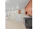 Compact kitchen featuring wooden cabinets and white appliances, providing essential amenities at 5703 Field St, Arvada, CO 80002