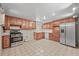 Eat-in kitchen with stainless steel appliances and vintage tile flooring at 5703 Field St, Arvada, CO 80002