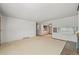 Bright living room with neutral carpet, decorative wall and an opening to a dining space at 5703 Field St, Arvada, CO 80002