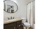 Cozy bathroom with granite vanity, modern fixtures, toilet, and shower with curtain at 1302 Milbury St, Castle Rock, CO 80104