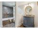 Well-lit bathroom featuring a tub, vanity, and a modern sink with a granite countertop at 1302 Milbury St, Castle Rock, CO 80104