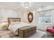 Stylish bedroom with a decorative mirror, patterned storage trunk, and ambient lighting at 1302 Milbury St, Castle Rock, CO 80104