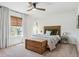 Cozy bedroom with a wooden bed, decorative pillows, window, and stylish furnishings at 1302 Milbury St, Castle Rock, CO 80104