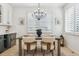 Dining room with plantation shutters, a modern light fixture, and light hardwood floors at 1302 Milbury St, Castle Rock, CO 80104