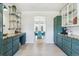 A bright kitchen boasts custom green cabinetry, a decorative shelving unit, and a view into the dining room at 1302 Milbury St, Castle Rock, CO 80104