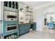 The open-concept kitchen features custom green cabinetry, stainless steel appliances, and hardwood floors at 1302 Milbury St, Castle Rock, CO 80104