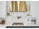 The chef's kitchen features quartz countertops, a gas cooktop, and custom white cabinets at 1302 Milbury St, Castle Rock, CO 80104