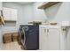 Functional laundry room with modern washer, dryer, storage cabinets, and practical shelving for supplies at 1302 Milbury St, Castle Rock, CO 80104