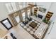 An aerial view of a stylish living area featuring tall ceilings and windows and a fireplace with decor shelving at 1302 Milbury St, Castle Rock, CO 80104