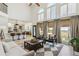Bright, open-plan living area with tall windows, ceiling fan, and a view into the well-equipped kitchen at 1302 Milbury St, Castle Rock, CO 80104