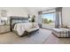 Tranquil main bedroom with a large window showcasing outdoor views, complemented by comfortable furnishings at 1302 Milbury St, Castle Rock, CO 80104