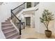 Grand staircase with wrought iron railings leading to upper levels and a built in wine storage at 1302 Milbury St, Castle Rock, CO 80104