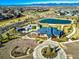 Aerial view of community amenities, including a pool, clubhouse, and green spaces at 30 Sun Up Ct, Erie, CO 80516