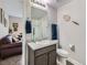 Bathroom featuring a modern vanity with granite countertop and a glass-enclosed shower at 30 Sun Up Ct, Erie, CO 80516
