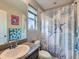 This bathroom features a granite vanity and a shower with a blue starfish shower curtain at 30 Sun Up Ct, Erie, CO 80516