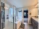 Bathroom with soaking tub, glass shower, modern finishes, and beautiful natural light at 30 Sun Up Ct, Erie, CO 80516