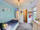 Bright bedroom with playful decor, carpet flooring and a closet with shelving at 30 Sun Up Ct, Erie, CO 80516