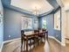 Dining room featuring a large wooden table, stylish chandelier, wood floors, and lots of natural light at 30 Sun Up Ct, Erie, CO 80516