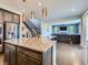 Open concept kitchen with granite countertops, stainless steel appliances, and view to the living room at 30 Sun Up Ct, Erie, CO 80516