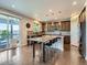 Bright kitchen with a large island, stylish pendant lighting, and access to an outdoor patio at 30 Sun Up Ct, Erie, CO 80516