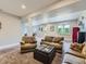 Spacious open-concept living room with lots of natural light, cozy seating, and carpet at 30 Sun Up Ct, Erie, CO 80516