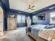 Main bedroom with blue walls, ceiling fan, comfortable bed, and plenty of natural light at 30 Sun Up Ct, Erie, CO 80516