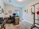 Bright office with a wood desk, comfortable chair, and pull-up bar for exercise at 30 Sun Up Ct, Erie, CO 80516