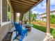 Covered patio with seating area, fire pit, and view of the landscaped backyard at 30 Sun Up Ct, Erie, CO 80516