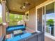 Covered patio with comfortable seating, ceiling fan, and sliding door entrance at 30 Sun Up Ct, Erie, CO 80516