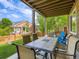 Covered patio with a large outdoor dining table, chairs, and a view of the backyard at 30 Sun Up Ct, Erie, CO 80516
