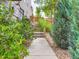 Landscaped walkway with decorative stone pavers leading up to a gated backyard at 30 Sun Up Ct, Erie, CO 80516