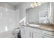 Well-lit bathroom with subway tile shower, granite counters, and white cabinets at 4260 E Warren Ave # 5, Denver, CO 80222