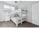 Bright bedroom with bunk beds, neutral colors, and a large window at 4260 E Warren Ave # 5, Denver, CO 80222