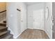 Welcoming entryway with hardwood floors, coat hooks, and access to the staircase at 4260 E Warren Ave # 5, Denver, CO 80222