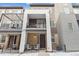 Charming townhome exterior with brick accents, covered entry, and a small patio at 4260 E Warren Ave # 5, Denver, CO 80222