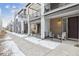 Modern townhome exterior featuring a covered porch with seating and balcony, providing a stylish and inviting curb appeal at 4260 E Warren Ave # 5, Denver, CO 80222