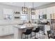 Bright kitchen features white cabinets, granite countertops, stainless steel appliances, and a center island with barstool seating at 4260 E Warren Ave # 5, Denver, CO 80222