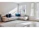 Sunlit living room featuring a cozy sectional sofa, a modern coffee table, and large windows for natural light at 4260 E Warren Ave # 5, Denver, CO 80222