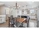 Open concept area with a dining table and a view of the kitchen and its kitchen island at 4260 E Warren Ave # 5, Denver, CO 80222