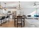 Open living space with a dining area, kitchen island, and a comfortable living room setup at 4260 E Warren Ave # 5, Denver, CO 80222