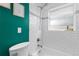 Bathroom features a tiled shower-over-tub, clean white fixtures, and a window for natural light at 1540 Filbert Ct, Denver, CO 80220