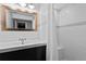 Bright bathroom featuring modern vanity, and white tile shower with seat at 1540 Filbert Ct, Denver, CO 80220