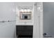Updated bathroom with gray vanity, updated mirror, and tile shower at 1540 Filbert Ct, Denver, CO 80220