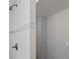Modern bathroom shower with tiled wall and contrasting grey band, offering contemporary design at 1540 Filbert Ct, Denver, CO 80220