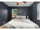 Bedroom with hardwood floors, ceiling fan, windows, and a plush bed with decorative pillows at 1540 Filbert Ct, Denver, CO 80220