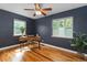 Bedroom featuring hardwood floors, a ceiling fan and 2 bright windows at 1540 Filbert Ct, Denver, CO 80220