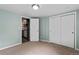 Bedroom with open door to kitchen, carpet floors and closet with sliding doors at 1540 Filbert Ct, Denver, CO 80220